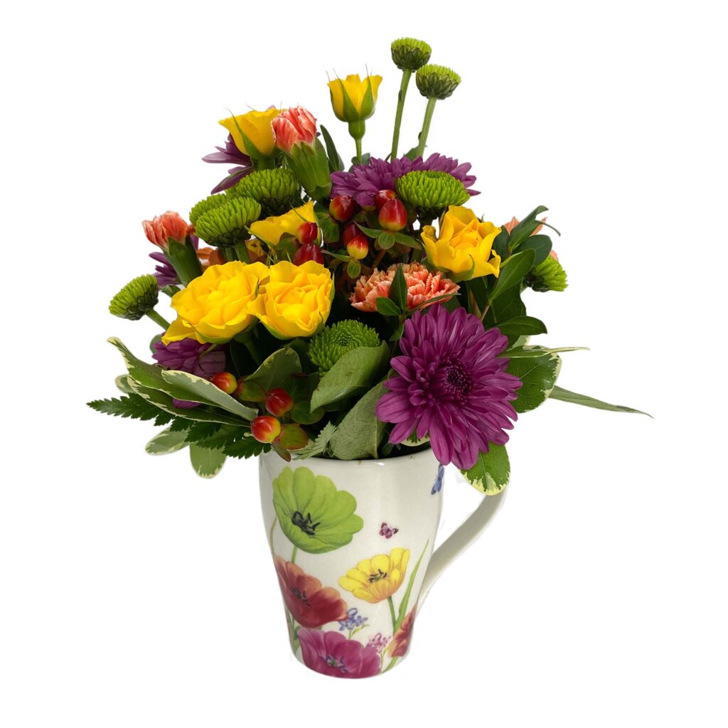 Colorful floral arrangement in a decorative mug for gift occasions like birthdays and anniversaries.
