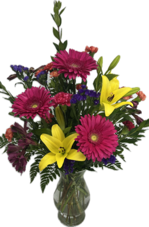 Bright colorful flowers arranged in a clear glass vase.