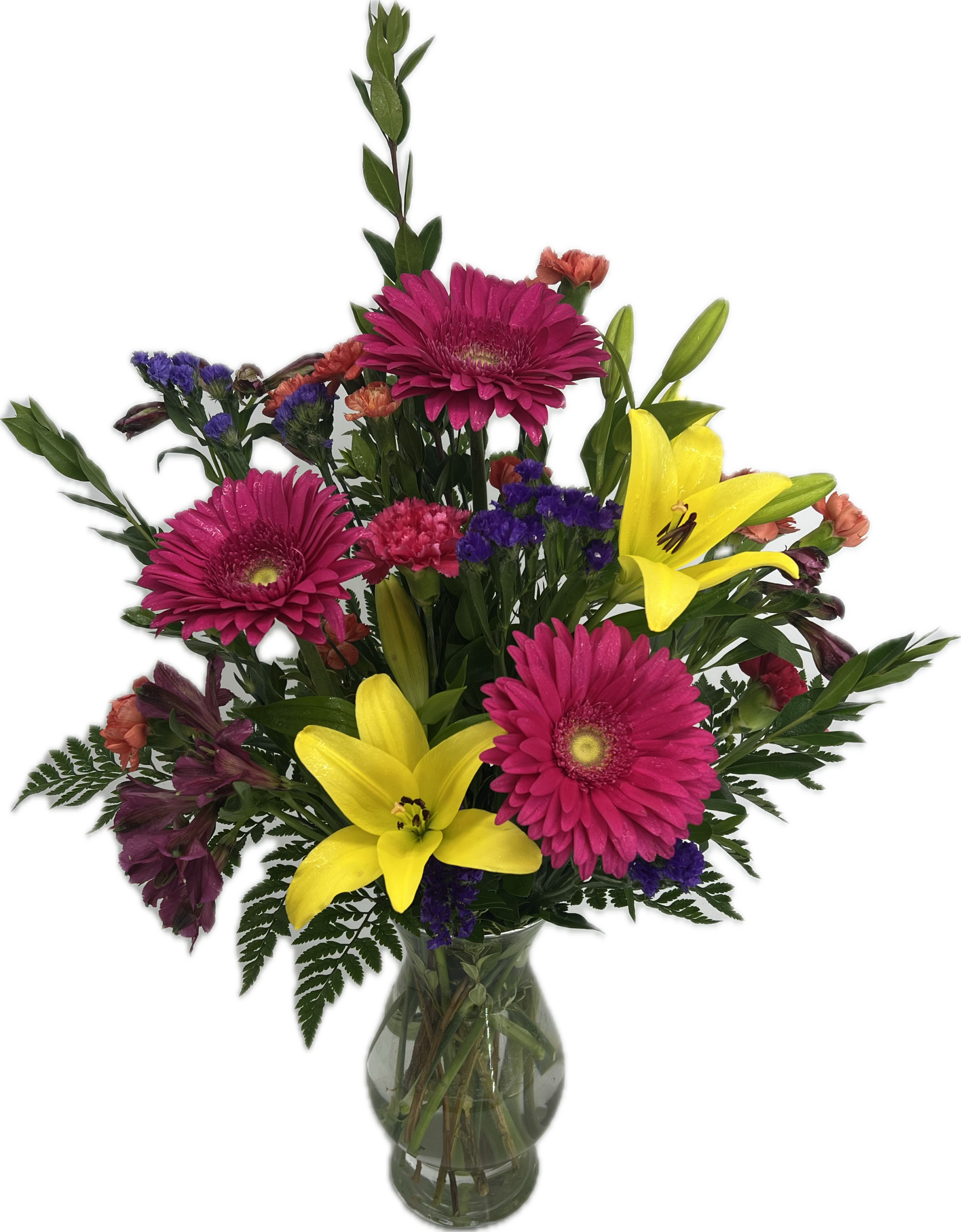 Bright colorful flowers arranged in a clear glass vase.